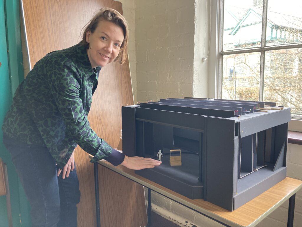 DESIGNER LOUIE WHITEMORE WITH THE THEATRE SCALE MODEL